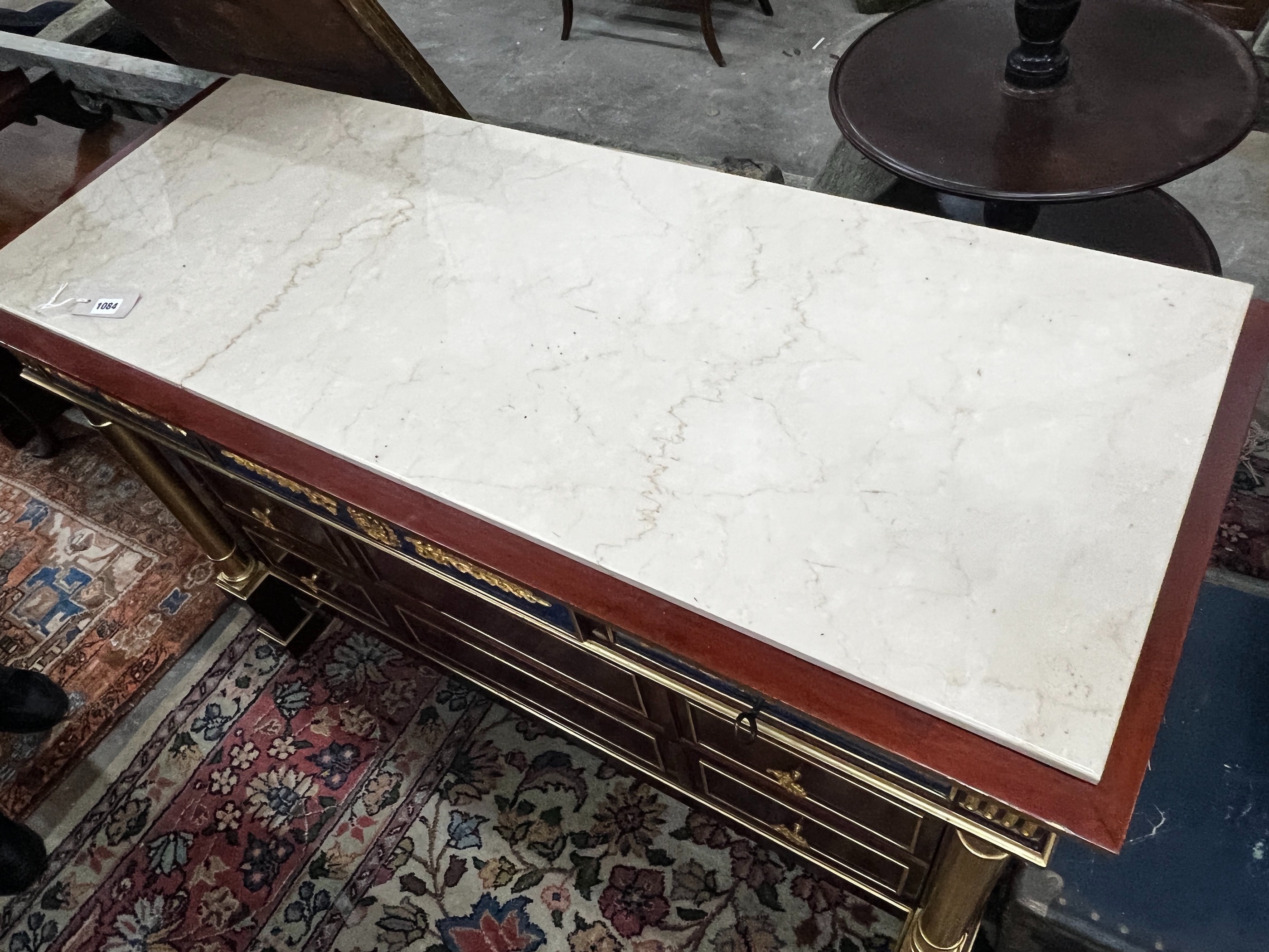 An Empire style faux malachite parcelgilt mahogany marble top commode, width 130cm, depth 50cm, height 85cm